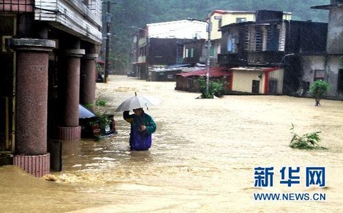 10月21日，台湾宜兰县苏澳地区居民在洪水中艰难出行。新华社发 